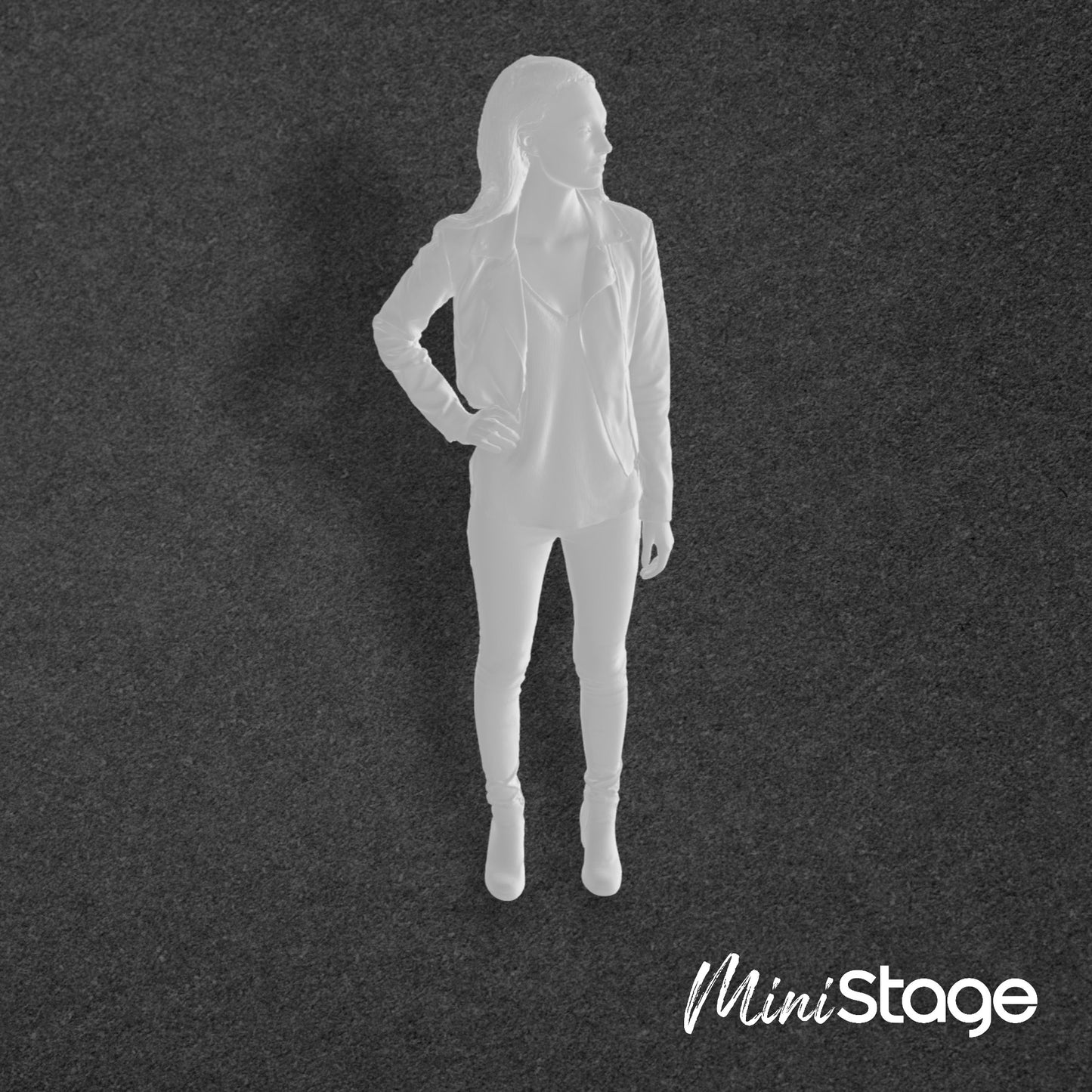 Abigail - Scale Model Box Unpainted Figure of Woman wearing leggings, leather jacket and boots she stands with he right hand on her hip.